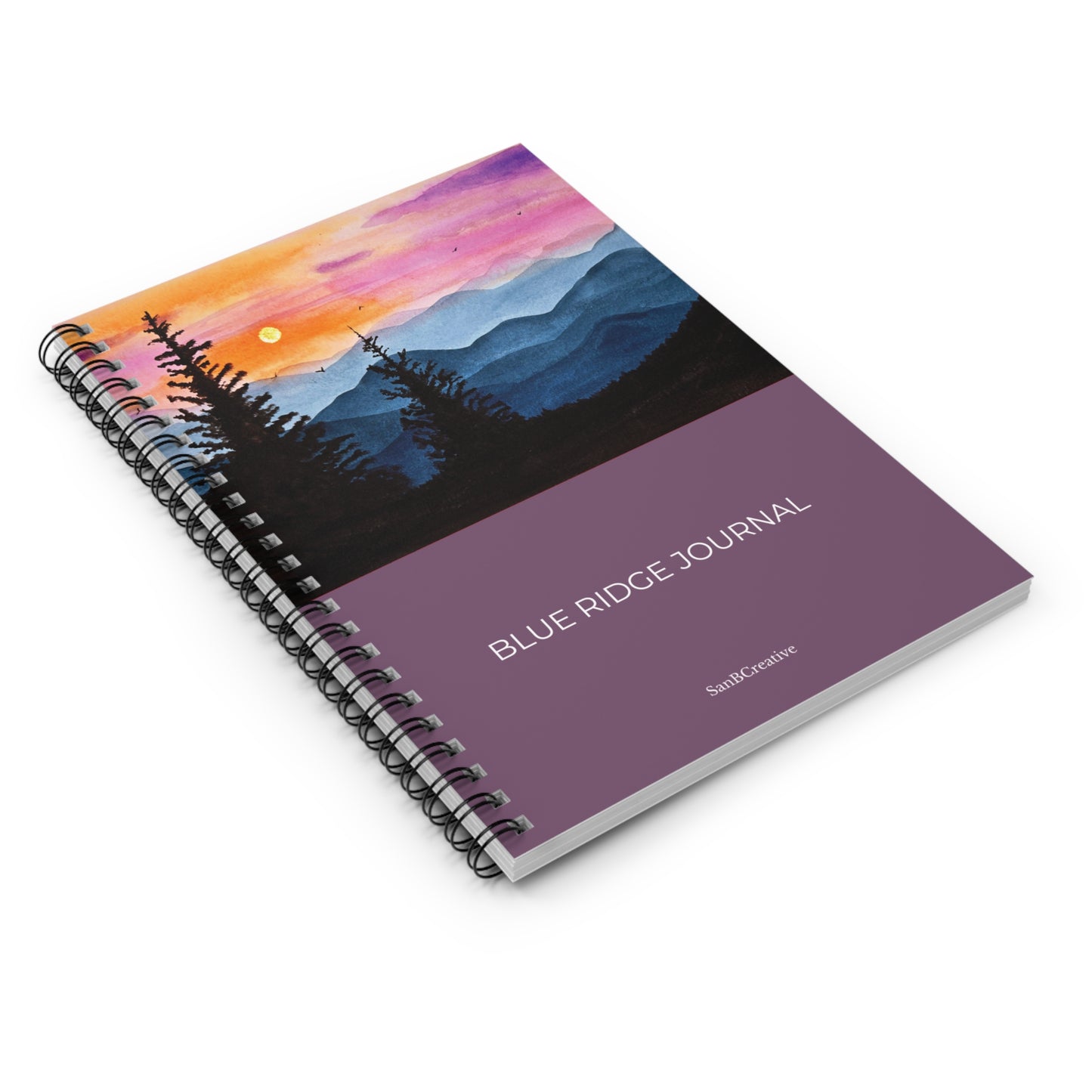 Spiral-bound notebook with a mountain landscape design on the cover