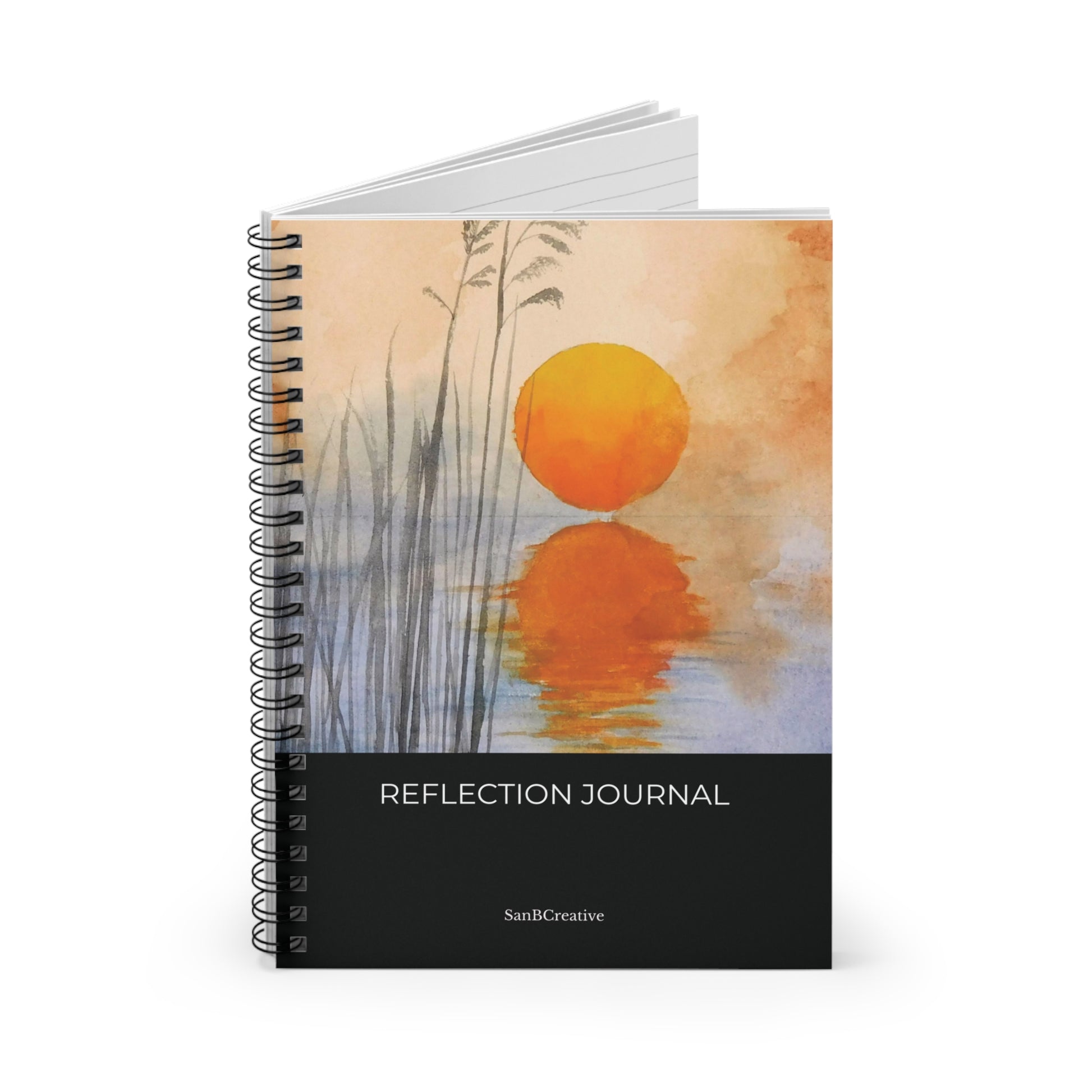 Spiral-bound notebook with sunset design and 'Reflection Journal' text on a white background