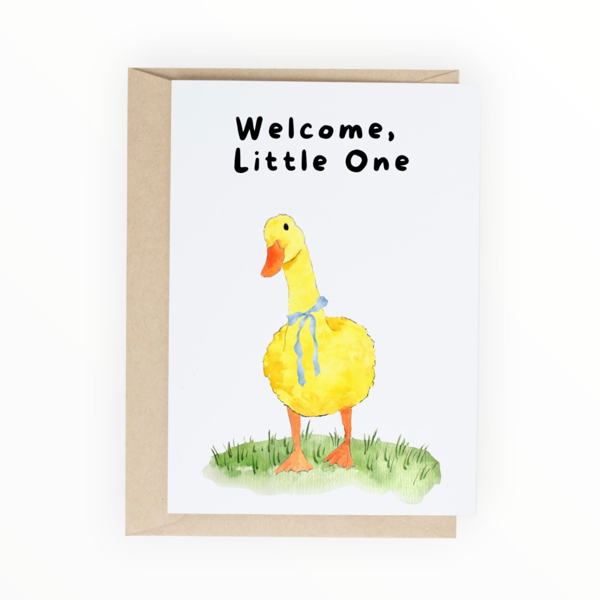 Yellow watercolor duck with a blue ribbon standing on grass with the words ‘Welcome, Little One.